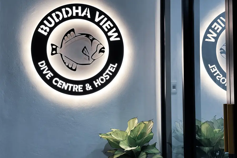 The backlit Buddha View sign glowing at night