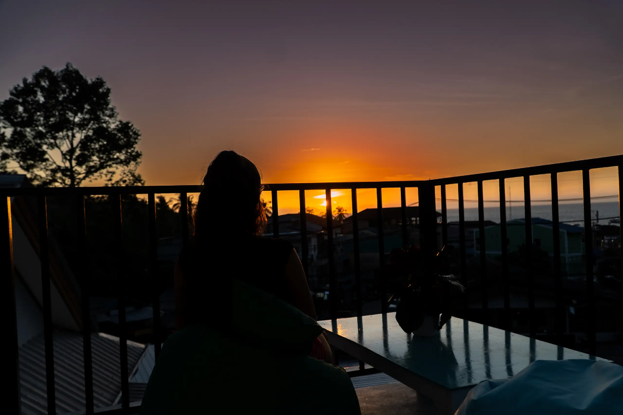 Rooftop terrace with bean bags at sunset over the village