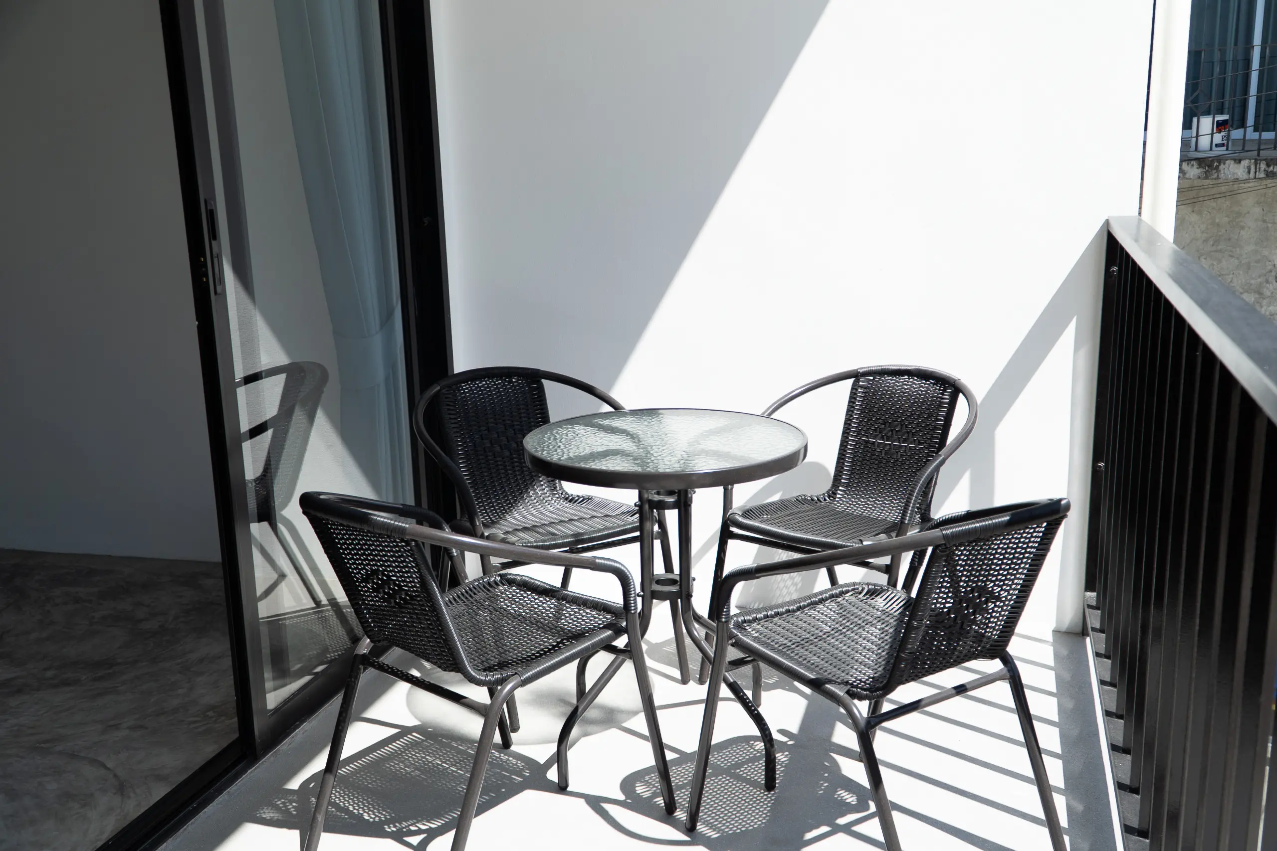 Private balcony with a round table and four chairs