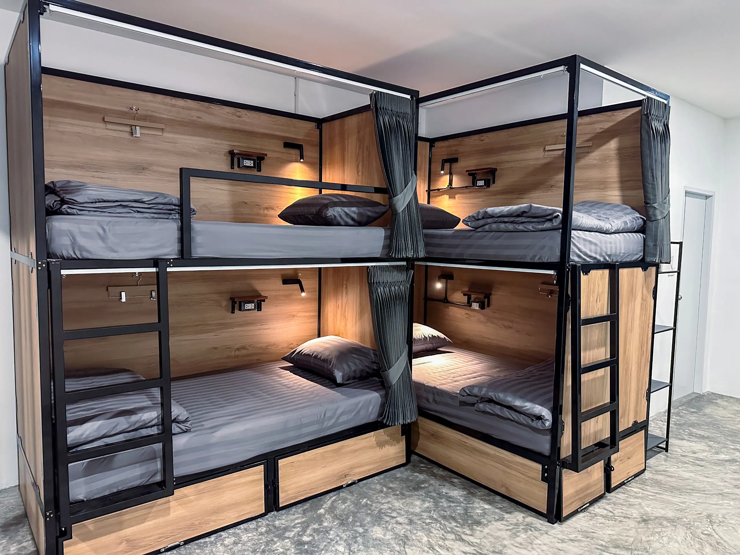 Bunks with wooden panelling and a privacy curtain drawn between them